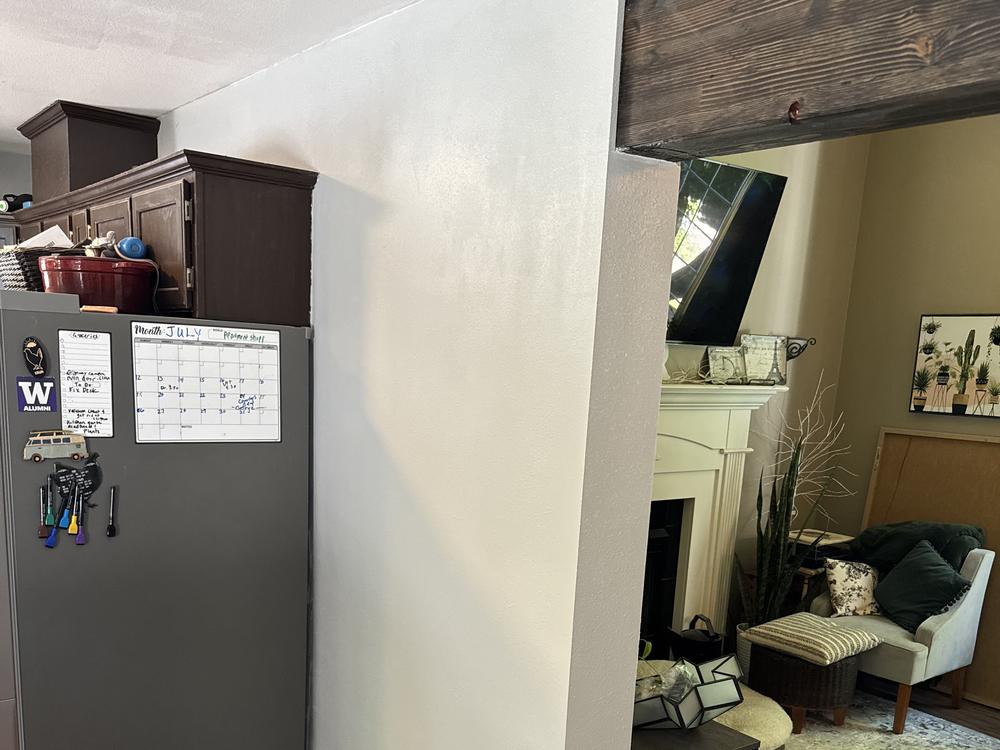 Finished opening between kitchen and living room with stained beam