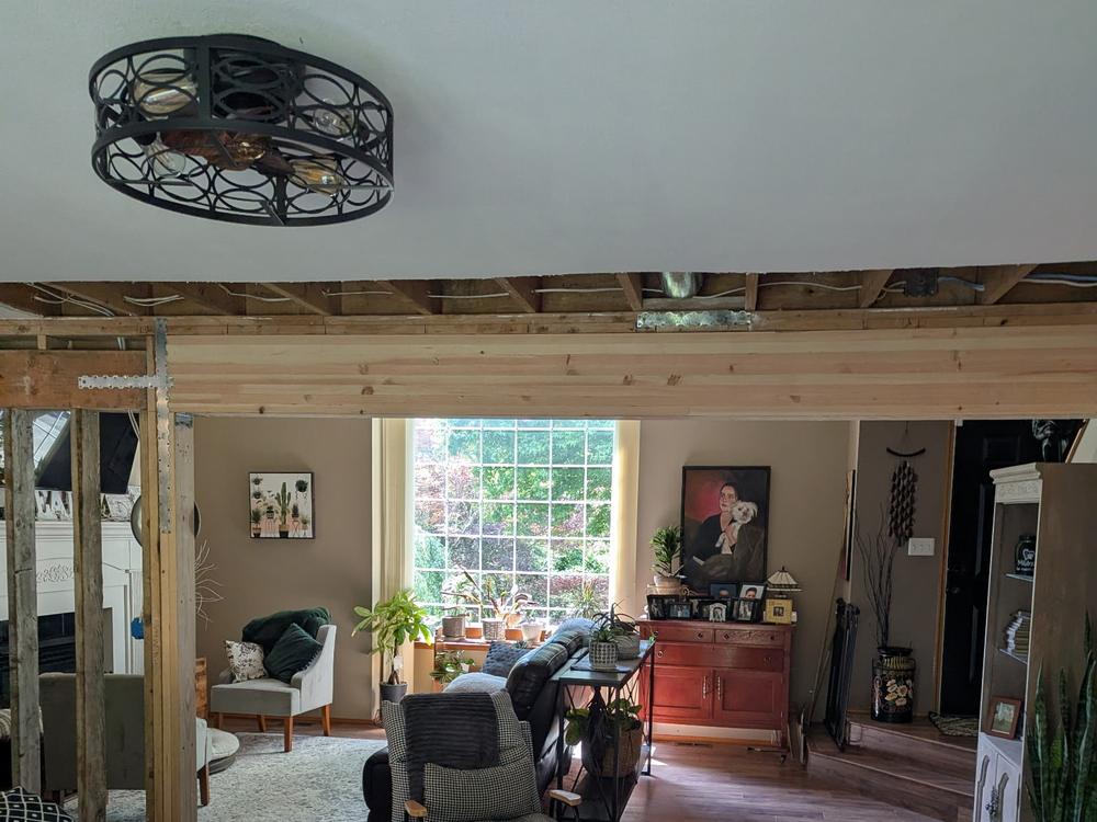 Load-bearing wall removed, ceiling opened, new beam being installed