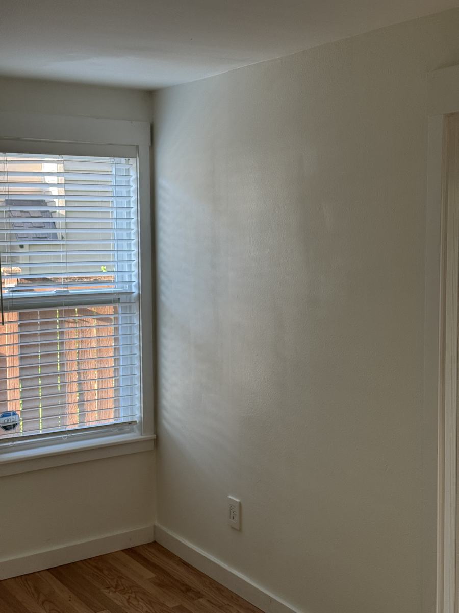 After — wall rebuilt, textured, painted and trimmed